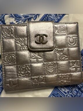 Authentic CHANEL Metallic Silver Embossed CC Symbols Bifold Leather Wallet COA